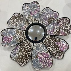 A decorative mosaic floral wall mirror