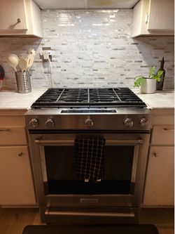 KitchenAid  5 burner stove with the cooker hood and the microwave