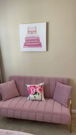 Pink couch with gold arm rests