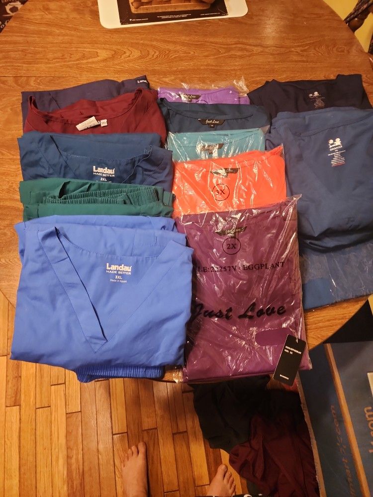 A LARGE BUNDLE OF PLUS SIZE SCRUBS.