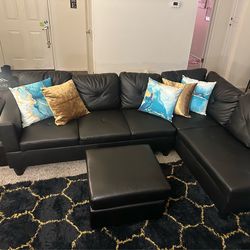 Black Faux Leather L-Shaped Sectional Couch + Ottoman (NEED GONE ASAP!)