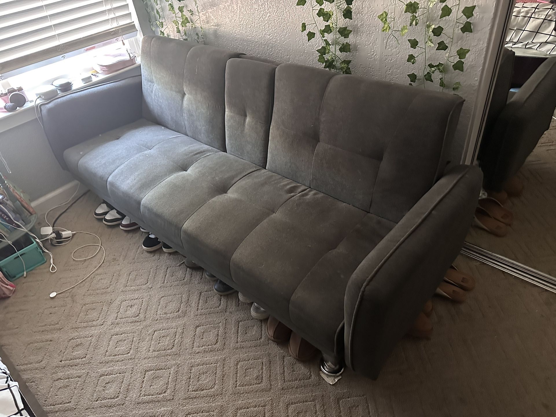 Grey futon with grey legs, and cup holders!
