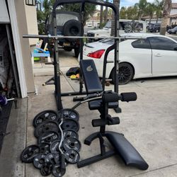 Nautilus bench press/squat rack with pulley system and 275lbs of Olympic weights plus curl bar