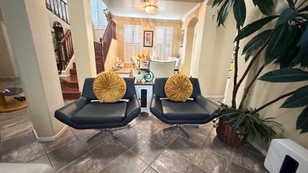 Beautiful swivel wide faux leather accent chairs in excellent condition