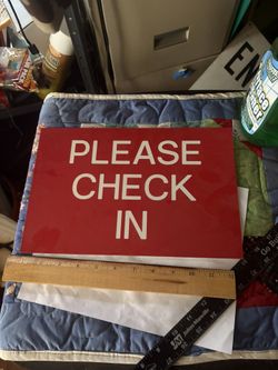 A plastic sign in check sign 