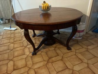 Dining room table with four additional leaves 10 inches wide each the table is solid wood 54 inch diameter Dining room table with four additional leav