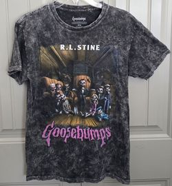 GOOSEBUMPS Slappy Doll- R.L. STINE~
Halloween Black-TV Show. T-SHIRT Showcases a Vibrant Horror-themed illustration of Slappy and other iconic charact