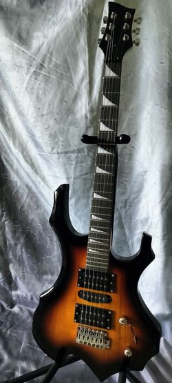 Brand new electric guitar with new bag cable and shoulder strap