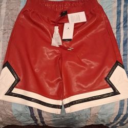 Nike Air Jordan Faux Leather Diamond Shorts in the Red/Sail/Sierra Red colorway 