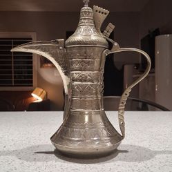 A Middle-Eastern white metal Dallah coffee pot
