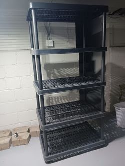 3 different sized plastic storage racks