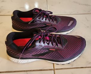 Brooks Ghost 12 women's running shoes in purple and black with bright pink accents.