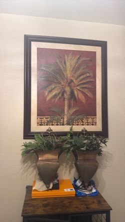Two hanging plants and wall art