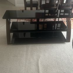 Black Glass Tv Stand With Brown Trimming