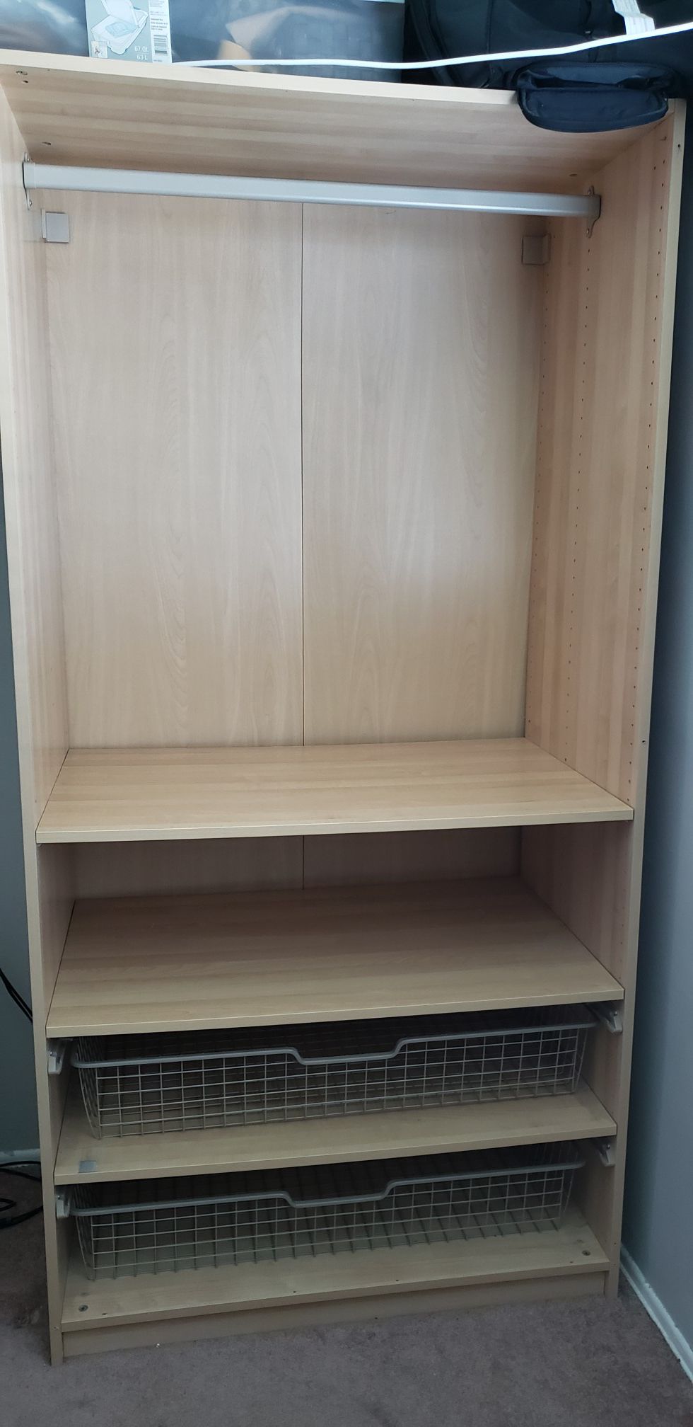 IKEA closet with wire shelves and hanging rod