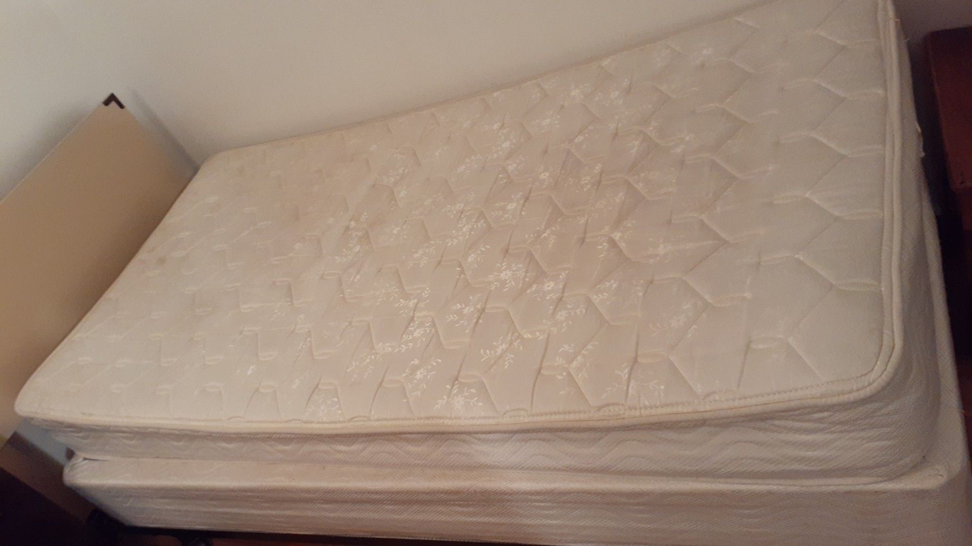 Bed with mattress and metal wheels