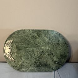 vintage green marble cheese or charcuterie serving board. Decorated silver-plated grapes.