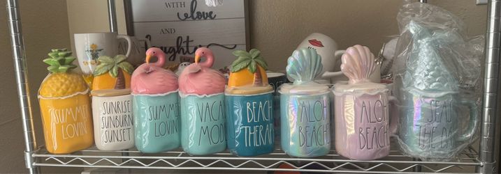 Rae Dunn mugs with toppers