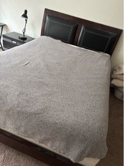 Bed with mattress and side table