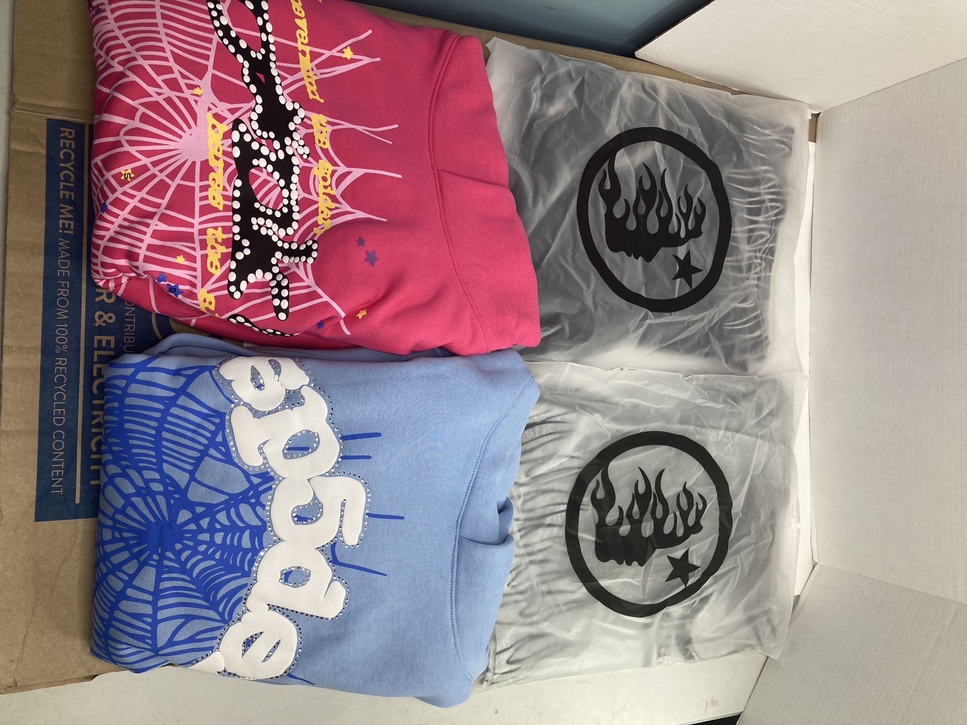 Two Hellstar Yoga Black And Grey Tees And Two Spider Hoodies V2 Pink And Sky Blue With Rhinestones All Larges Except Pink V2 That’s A Medium