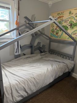 Grey twin bed with trundle