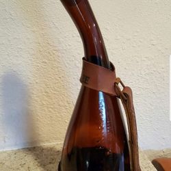 Empty Dickel tennessee whiskey vintage bottle with leather
