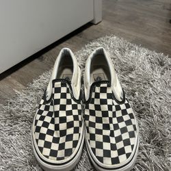 Black and white slip on vans 