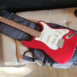 Red Fender Squier Electric Guitar With Qmp, Cables, Case, Strap, Capo And Some Replacement Strings