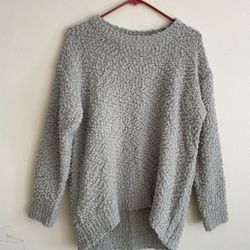 This is a very soft and textured grey knitted sweater. • Popcorn Knit: This uneven, small ball-like surface texture is often referred to as "Popcorn K