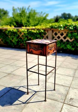 vintage-style wrought iron side table featuring a distressed, warm-toned hand-painted finish and decorative scrollwork.8.5"×22.5"
