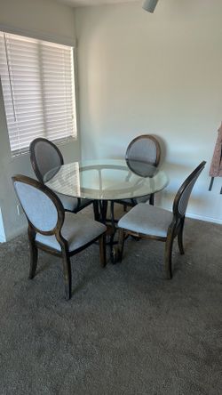 Glass dining table with four chairs