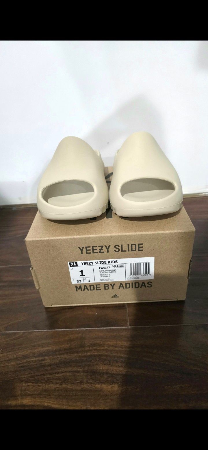 Brand new yeezy slide bone kids size 1 with box.