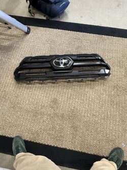 Gloss black front upper grille for a 2016-2019 Toyota Tacoma