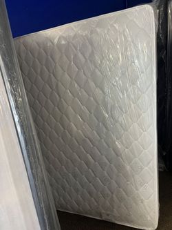 White Quilted Mattress Still in Plastic