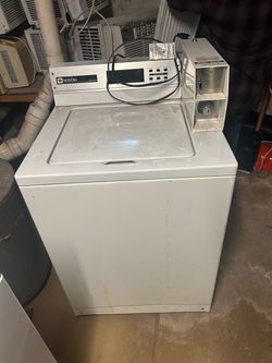 Coin operated washing machine Great for landlords and tenants .