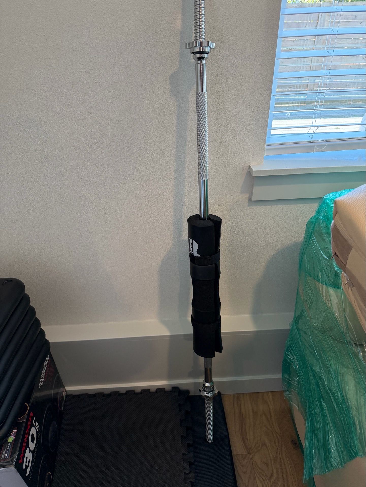 Barbell with pad and extra weights