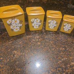 Vintage 1970s harvest gold floral canister set.