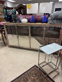 BRAND NEW Ashley Chaseton accent cabinet. It features a light wood finish with mirrored door fronts and chrome-tone pulls - 79” x 20” x 39” - Retail: 