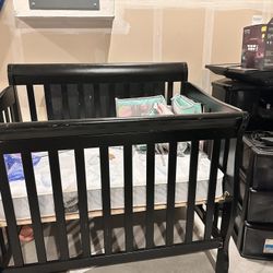 dark-colored (black or espresso) wooden sleigh-style convertible crib
