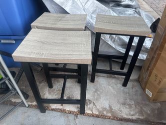 Three grey stools