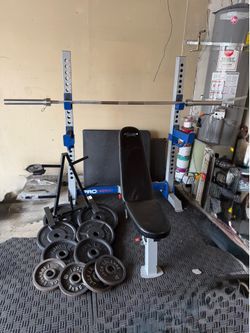 Bench press/squat rack with 7ft 45lbs bar and 250lbs of Olympic weights plus weights tree