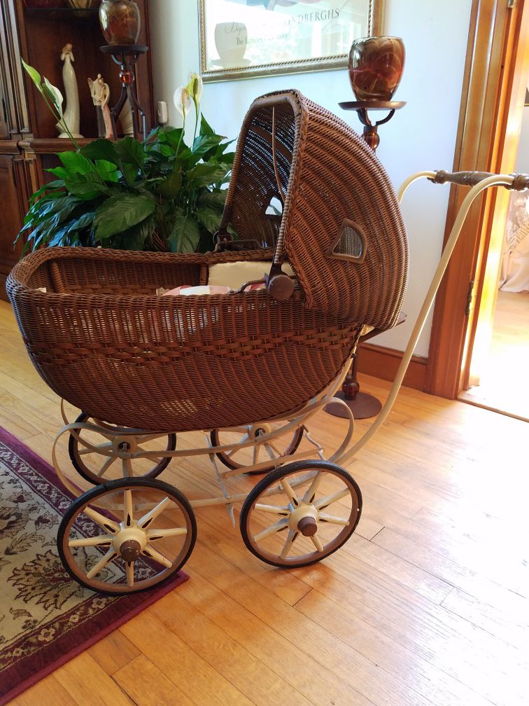 Antique wicker doll carriage makes a great decorative porch planter