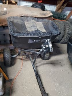 Agri-Fab tow-behind broadcast spreader.