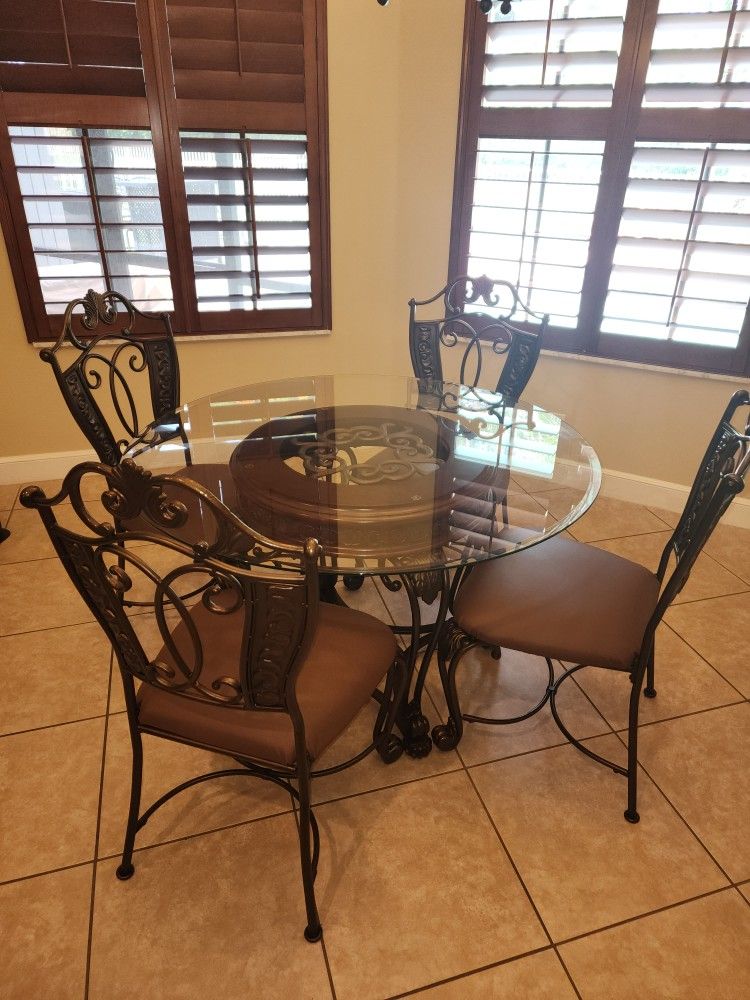 Kitchen Table, Chairs, and Matching Bar Stools. Table is 4 foot in diameter.  Seats four poeple.