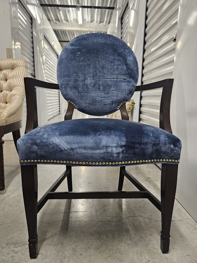 6  Chairs with arms, covered in blue velvet in dark wood. 
