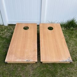 two large wood cornhole boards