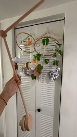 Crib mobile with arm
