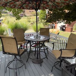 Outdoor table chairs and umbrella