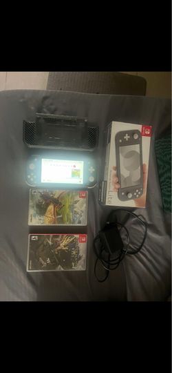 Lightly played grey Nintendo switch lite with case and games