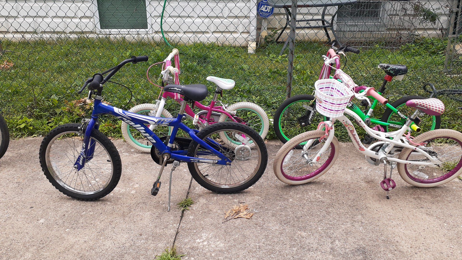 Kids bike for sale the small pink one Schwinn bike the girls bike is a swim two boys bike one is a rally the blue one the green one is a Kent